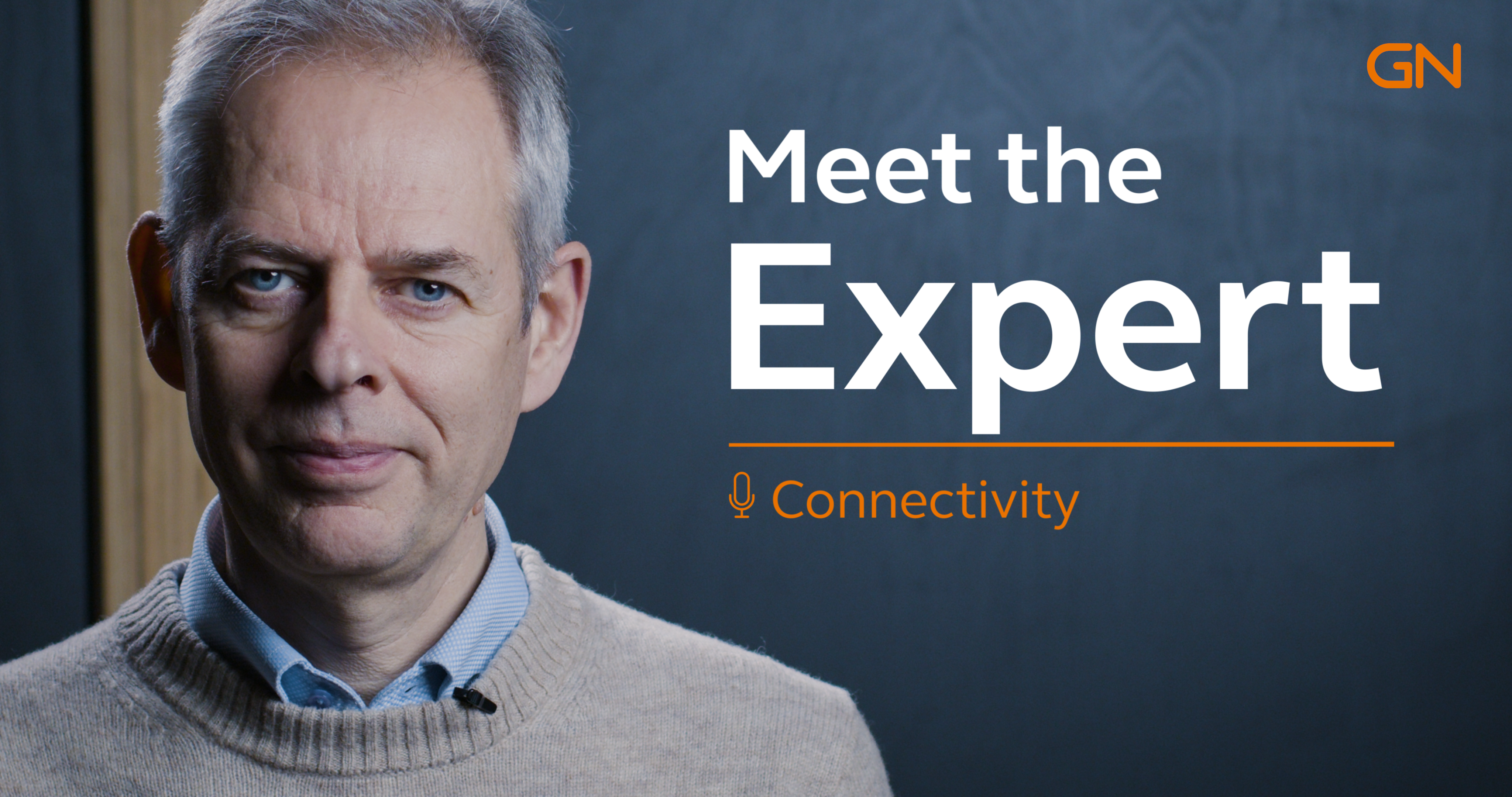 A man standing next to a blue background saying: ''Meet the Expert''