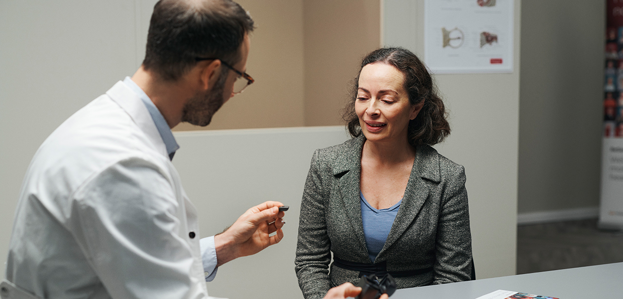 ReSound hearing care professional interacting with a patient during an appointment.